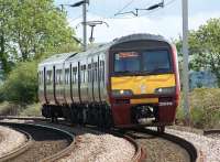 320318 heads west from Cardross at Brooks Farm level crossing on 28 May 2010 with a service to Helensburgh Central.<br><br>[John McIntyre 28/05/2010]