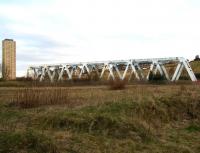 <I>'Ahhh would you look at that Ted - some eejit's gone and dumped an old bridge in that field...' </I> Not what it seems.. view of the the bridge carrying the Cumbernauld line over the M80 motorway, seen from Royston Road on 1 April 2007 [see image 14426].<br><br>[John Furnevel 01/04/2007]