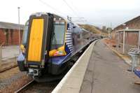 Glasgow bound 380108, on a service that started at the Harbour station, calls at Ardrossan Town. This station is much smaller than it originally was [see image 21659] but at least it is open to passengers again after being closed for a number of years. <br><br>[Mark Bartlett 08/03/2013]