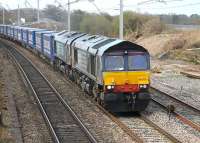 Working in multiple, DRS 66305+66424 skirt Morecambe Bay as they power through Hest Bank with the 4S43 Daventry to Mossend <I>Eddie Stobart Tesco Express</I>.<br><br>[Mark Bartlett 23/04/2013]