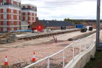 View from a train passing Balgreen tram stop on 6 May 2013. The iconic Jenners Furniture Repository stands on the left with Murrayfield Stadium in the right background.<br><br>[Bill Roberton 06/05/2013]