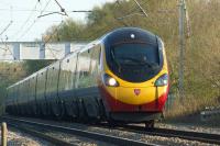 An 11 car Virgin Pendolino heads north towards Balshaw Lane Junction in the late afternoon sunshine with a Euston to Glasgow service on 6 May 2013.<br><br>[John McIntyre 06/05/2013]