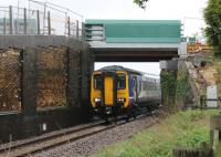 Pre-electrification works on the Blackpool line at Salwick in May 2013 saw a new bridge installed at the station, one of several on this line. 156426 passes the unfinished bridge over the down line in pouring rain on a Manchester Victoria to Blackpool North service. [See image 19130] for an earlier view at the same location.<br><br>[Mark Bartlett 11/05/2013]