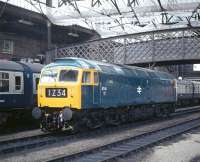 On 4th September 1976 Carlisle Diesel Depot hosted an open day, although whether ex-works 47141 had been stabled in a prominent position for the benefit of enthusiasts arriving by train I cannot say. With the station clock showing just after 11.30, the morning Leeds to Glasgow train waits to continue its journey northwards.<br><br>[Bill Jamieson 04/09/1976]