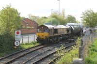 <I>On time as usual</I>. The loaded bitumen tanks from Lindsey, hauled by 66011, cross Strand Rd in Preston and roll onto Ribble Rail metals. The DBS loco will only be here for an hour or so while it deposits the fourteen loaded tanks for Ribble Rail transfer, collects the empties and then sets out for Lincolnshire again.<br><br>[Mark Bartlett 13/05/2013]