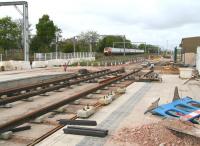 Looking over the city bound platform at the partially completed Balgreen tram stop on 12 May 2013 as a Virgin Voyager approaches on the parallel E&G main line heading for Waverley. [See image 43018]<br><br>[John Furnevel 12/05/2013]