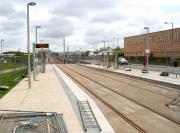 The tram stop at Edinburgh Park on 12 May 2013. View east from the station entrance pathway [see image 43070] towards the city centre. The LCD panels read 'Edinburgh Trams - Edinburgh Park Station - 10:04:34'<br><br>[John Furnevel 12/05/2013]