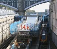 High level talks. Looking east from Waverley Bridge on 17 May 2013 as a discussion group meets on the roof of the new canopy being constructed over 'sub' platforms 8 and 9. Skulking below in the shadows is a Voyager, boarding as the 10.51 Virgin Trains service to Birmingham New Street.<br><br>[John Furnevel 17/05/2013]