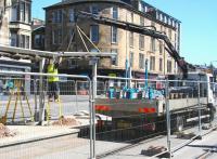 <I>'Left a bit...'</I>   Putting the finishing touches to the Haymarket tram stop on 17 May 2013. View is east along Haymarket Terrace with the station off to the right.<br><br>[John Furnevel 17/05/2013]