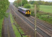 With Balshaw Lane Junction in the distance, a Northern service from Blackpool to Liverpool approaches Charnock Richard during a wet afternoon on 18 May.<br><br>[John McIntyre 18/05/2013]