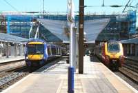 The changing view looking east along platforms 2 and 3 at Haymarket on 17 May 2013. Recently arrived at platform 2 is the 12.28 Edinburgh - Inverurie service, while the 08.20 Voyager ex-Birmingham New Street is preparing to leave no 3 on the final leg of its journey to Waverley.<br><br>[John Furnevel 17/05/2013]