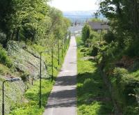 The view south from the A6094 road bridge towards the site of Hardengreen Junction on 22 May [see image 17896]. Just behind the pedestrian walking across the trackbed in the background the route is fenced off, with the works beyond associated with the construction of the new Eskbank station and car park. <br><br>[John Furnevel 22/05/2013]