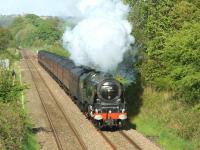 Trying to regain some lost time, 46233 <I>Duchess of Sutherland</I> makes an impressive sight as the <I>Cumbrian Mountain Express</I> approaches Pleasington station on the western outskirts of Blackburn on 22 May 2013. This leg of the tour was from Carlisle to Farington Junction via the S&C where steam would hand over to electric power [see image 43185].<br><br>[John McIntyre 22/05/2013]