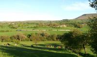 Looking south across the Ribble Valley just west of the former station at Rimington (closed 1958), DRS 47818 heads the <I>Northern Belle</I> with 47501 on the rear during the early evening on 25 May 2013. The train was returning to Crewe following a trip to Ravenglass. The eastern edge of Pendle Hill (infamous for witches) can be seen on the right of the picture.<br><br>[John McIntyre 25/05/2013]