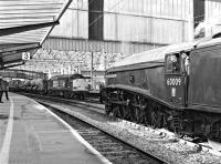 <I>Union of South Africa</I> stands on one of the centre roads at Carlisle on 27 October 2012 having arrived with <I>The Hadrian</I> charter from York via Newcastle. The locomotive is waiting to reverse down to Upperby with its support coach for turning. In the background No. 37605 and an unidentified sister loco stand on the other centre road with a Sandite train.<br><br>[Bill Jamieson 27/10/2012]