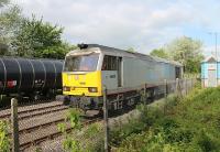 Class 60s still make occasional visits to Preston Docks with the Lindsey bitumen tanks and <I>Tata Steel</I> liveried 60099 is seen here running round at Strand Road exchange sidings having just arrived with the tanks seen on the left. Hidden behind the main line loco is a Ribble Rail Sentinel shunter waiting to haul the new arrivals to the Total terminal while 60099 will pick up the empties from the centre road for the run back to Lincolnshire.<br><br>[Mark Bartlett 29/05/2013]