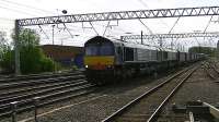 DRS 66302+66426 head 4S43 a very long 'Tesco Express' into and through Carlisle heading for Mossend<br><br>[Ken Browne 22/05/2013]