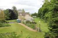 Humshaugh opened as Chollerford but was later renamed after the larger, but more distant, village of that name. Closed with the Border Counties line in 1956, this view looks north towards Reedsmouth over the old station, now a private residence.<br><br>[Mark Bartlett 05/06/2013]