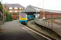 An ATW service arrives at platform 2 at Holyhead on 29 May 2013. Platform 3 is to the right outside the train shed while platform 1 is on the other side of the access road to the left.<br><br>[John McIntyre 29/05/2013]