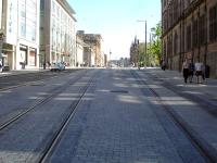 View up the significant gradient on the section of tramway along North St Andrew Street between York Place and the St Andrew Square tram stop showing the tracks coming closer together as they reach the turn into York Place behind the camera.<br><br>[David Pesterfield 04/06/2013]