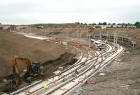 After passing below the A8 trams turn sharp left before the stop at Edinburgh Gateway, seen under construction centre left on 10 June 2013. The tracks running straight ahead will access Gogar tram depot on the other side of the bridge. Top right will be the new station, about to be passed by the 09.52 Aberdeen - Kings Cross HST. Access for buses, cars etc will be via the overbridge far left off the Gogar Roundabout, passing through the interchange and returning the same way.<br><br>[John Furnevel 10/06/2013]