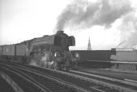 A3 Pacific no 60082 <I>Neil Gow</I> does its best to blot out the Tyne Bridge and All Saint's Church as it brings a parcels train across the Tyne and off the High Level Bridge in the early 1960s. Gateshead East station stands in the background, although the train is being routed through Gateshead West and past 52A towards King Edward Bridge Junction and the ECML.<br><br>[K A Gray //]