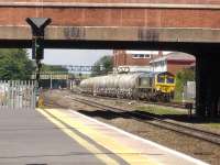 Freightliner 66596 approaching Slough Station eastbound on 5 June with a rake of empty cement tanks believed to be returning from Theale to Hope. The left side feathers on the signal ahead are for the Windsor branch.<br><br>[David Pesterfield 05/06/2013]