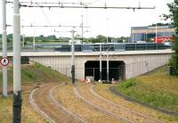 Looking north along the Edinburgh tram route shortly after leaving Gyle Centre in June 2013, with the line dropping down to pass below the A8 to reach Edinburgh Gateway [see image 43371]. Gogar roundabout is just off-picture to the left.  <br><br>[John Furnevel 07/06/2013]