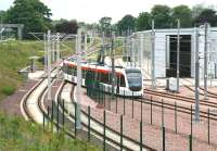 An Edinburgh tram comes off the 'main line' and runs into the depot sidings at Gogar on 10 June following a test run to the airport.<br><br>[John Furnevel 10/06/2013]