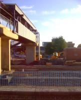 New platforms and footbridge taking shape on the West side of Peterborough on 7th June 2013. Seen from a train heading for Stansted Airport.<br><br>[Ken Strachan 07/06/2013]