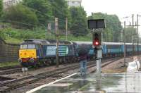 DRS 47501 with 5 Mk2 coaches in DRS livery arrives at Preston station on 12 June 2013 in less than ideal conditions as evidenced by the gentleman with umbrella. The coaches were part of an ecs move from Eastleigh to Carlisle.<br><br>[John McIntyre 12/06/2013]