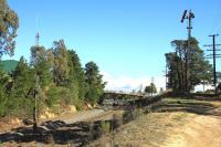 On the line from Melbourne Southern Cross to Albury and Wodonga, these ancient somersault signals are still in use at Broadford Station in 2013. The down home is at the trackside and its repeater on the top of the cutting. The tracks are, L to R, interstate standard gauge and 5'3' up and down.<br><br>[Colin Miller /06/2013]