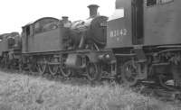 A pair of 2-6-2 tanks on shed at Neyland, Pembrokeshire (87H) in October 1961. BR Standard Class 2 82042 stands nearest the camera with ex-GWR 4557 beyond.  Neyland shed closed in August 1963<br><br>[K A Gray /10/1961]