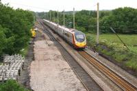 Looking north over Balshaw Lane Jct as a Pendolino speeds south on 23 June 2013. Work has commenced in preparation for the complete rebuilding of the junction (and two others between Euxton Jct and Warrington Bank Quay) during a 9 day possession from 13 to 21 July.<br><br>[John McIntyre 23/06/2013]