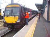 You know when you've been Tango'd! An LNWR employee's high-vis' vest lends some welcome colour to Cross Country Trains Turbostar 170522 forming the 16.01 to Birmingham New Street at Cambridge on 9 June.<br><br>[Ken Strachan 09/06/2013]