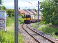 The 11.12 from Glasgow Central comes round the curve through the site of the old Hawkhead station on 24 June 2013. This is as close to the 1960 shot of the Black 5 [see image 26660] as I could get, given that the down line is gone and the tree growth has taken over. <br><br>[Colin Miller 24/06/2013]