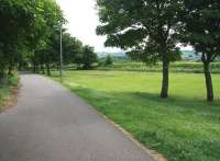 Looking north east towards the site of Esk Valley Junction in June 2013, more than 46 years after the last train passed through. The embankment on the right carried the Peebles loop between Bonnyrigg and Eskbank, closed in 1967. The route straight ahead brought in the Esk Valley branch from Polton [see image 7418], closed 3 years earlier. Both former routes are now walkways.  <br><br>[John Furnevel 25/06/2013]