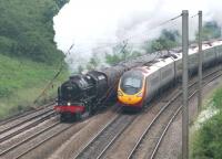 With around 75 years of development separating them two generations of West Coast Main Line express motive power meet at Farington Curve Junction. 46115 <I>Scots Guardsman</I> is routed on to the East Lancashire line with <I>The Fellsman</I> while the <I>Pendolino</I> is heading north on a Glasgow service.<br><br>[Mark Bartlett 26/06/2013]