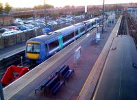 A Turbostar for Norwich ready to set off from north end bay platform 5 at Cambridge nearing dusk on a summer Friday evening in June 2013. Taken from the footbridge to the recently built island platforms.<br><br>[Ken Strachan 07/06/2013]