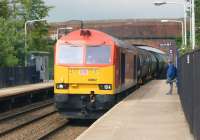 The empty tar wagons from Preston Docks (Lanfina) run through Lostock Hall station on their way back to Lindsey Oil Refinery, Immingham, on 26 June. The locomotive in charge is DBS 60092.<br><br>[John McIntyre 26/06/2013]