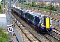 On 24 June the 12.25 Glasgow Central to Gourock passes Arkleston Junction on the down Gourock line. These tracks are now partially laid on the solum of the former Renfrew branch.<br><br>[Colin Miller 24/06/2013]