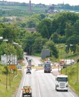 View south over Hardengreen roundabout on 25 June 2014.  Part of Newbattle Viaduct is visible in the centre, with the Lady Victoria Colliery site beyond. The spire of Gorebridge parish church stands on the horizon top right. [See image 47129]<br><br>[John Furnevel 25/06/2013]