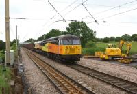 A dull midsummer day at Balshaw Lane Junction on 23 June is brightened by the appearance of Colas Rail Freight 56302 and 66850. The locomotives are heading north with the Chirk to Carlisle empty log wagons.<br><br>[John McIntyre 23/06/2013]