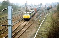 Freightliner 86602 and friend double heading the Basford Hall - Coatbridge containers north through Beattock station on a misty morning in April 1999. Timber loading activity has been taking place in the sidings on the west side of the line.<br><br>[John Furnevel 05/04/1999]