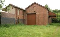 The east end of the goods shed at Halton on 30 June 2013 showing that, unlike the west end, [see image 18185] the door appears to be original. The shed and attached station building (closed to passengers in 1966) are in excellent condition with the covered doorways on the right side retained although not apparently in use.<br><br>[John McIntyre 30/06/2013]