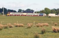 Glasgow bound 334033 heads towards Ardmore East level crossing on the evening of 1 June 2013. The River Clyde is immediately behind the camera.<br><br>[John McIntyre 01/06/2013]