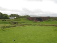 The rail underbridge on the road running NE to Gilmourton from the A71 north of Drumclog, South Lanarkshire, in June 2013. The old bridge was in use at the time as an avant-garde sheep shelter.<br><br>[David Pesterfield 15/06/2013]