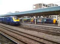 Three generations at Temple Meads on a spring Sunday afternoon in 2013. The HST (1970s) is heading for Paddington with 43029 leading, while the 37 (1950s) and the 66 (2000s) are stabled in the siding [see image 43161]. That derelict sorting office keeps turning up in the background!<br><br>[Ken Strachan 19/05/2013]