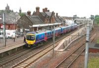 The 12.00 Manchester Airport - Edinburgh Waverley calls at Lockerbie on 11 June 2013.<br><br>[John Furnevel 11/06/2013]