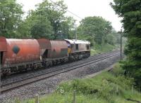 A Bescot Down Yard to Shap Summit Quarry train of empty stone hoppers passes through Bay Horse on its way north in June 2013.  DBS 66099 is in charge of the working and just about to meet K4 61994 and the <I>Fellsman</I> heading south [See image 43370].<br><br>[Mark Bartlett 12/06/2013]